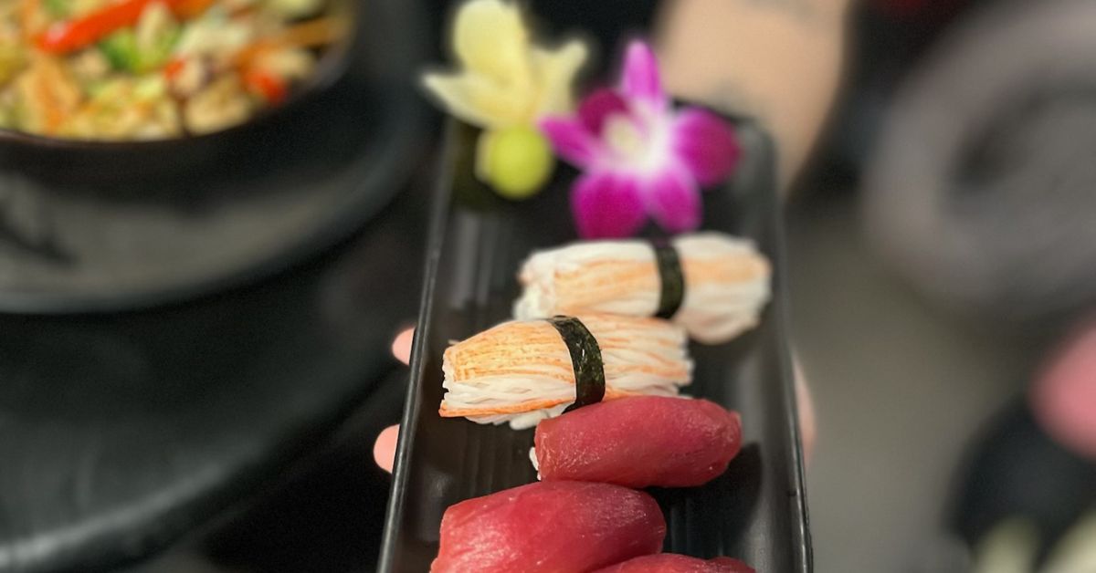 khons server holds a tray of fresh Sushi in Downtown Pensacola